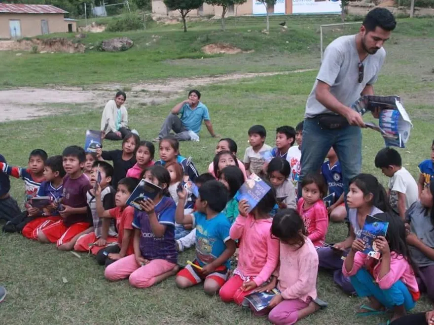 Handing out books to children